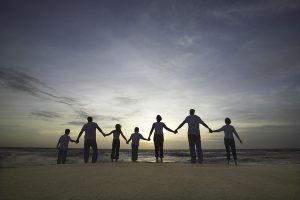 Family holding hands on beach