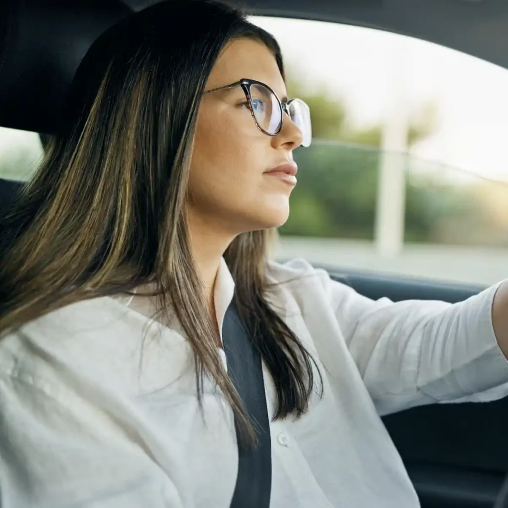 Woman with glasses driving