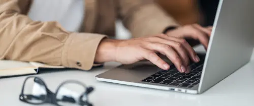hands typing on keyboard