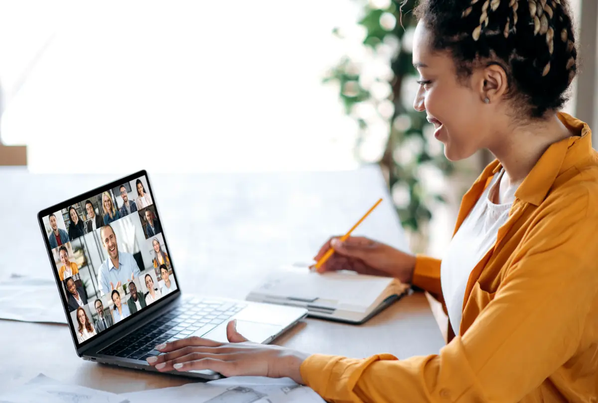 Inline briefing, conference. African American female manager communicates with business team during video call, listens financial webinar, takes notes